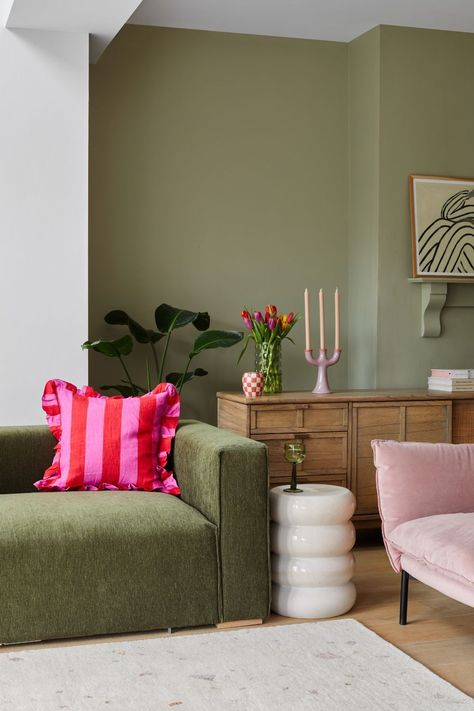 Sage Green Room Accents, Green Accent Colors Living Room, Different Shades Of Green Living Room, Green Sofa Mid Century Living Room, Living Room Inspo Green Sofa, Colourful Neutral Living Room, Oliver Bonas Living Room, Green Sofa Pink Rug, Pink And Green Mid Century Modern