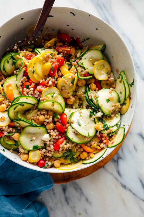 This couscous salad recipe with raw squash and bold Greek flavors is a simple, light summer dish. Full of vegetables, whole grains and chickpeas, it’s a complete meal in itself! #couscoussalad #couscous #pastasalad #summerrecipe #cookieandkate Healthy Barbecue, Mediterranean Couscous Salad, Couscous Salad Recipes, Mediterranean Couscous, Summertime Salads, Couscous Salat, Squash Pasta, Potluck Dishes, Couscous Salad