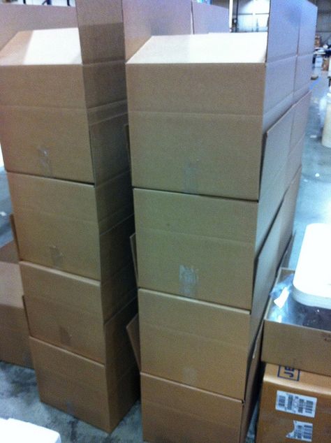 While we reuse and recycle our cardboard boxes, some clients prefer to use new boxes, or their own branded cartons for shipping.  We're happy to oblige!  Here's a stack of new boxes just waiting for some shirts.  www.visualimp.com Big Cardboard Boxes, Camp Jupiter, Reuse And Recycle, Business Baby, Courier Service, Cardboard Box, Work Hard, Basement, Recycling