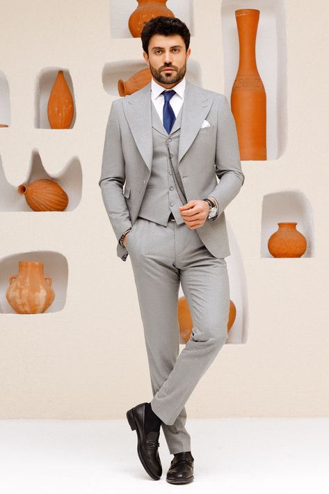 Elevate your style with this grey 3-piece slim-fit suit. The wide lapels on the jacket create a bold statement, while the matching lapels on the vest complete the look. Perfect for any event where you want to make a lasting impression. #mensfashion #mensstyle #menssuits #menswear #suitup #classicstyle #timelessfashion #gentlemanstyle #dapperlook #formalattire Blazer Waistcoat, Grey Slim Fit Suit, Suit Styles, Double Breasted Tuxedo, Suit Stores, Slim Fit Suit Men, Classy Suits, Slim Fit Tuxedo, 2 Piece Suit