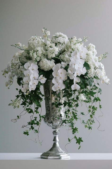 Floral centerpieces offer timeless elegance and countless ways to bring personality to your wedding. See more ideas here. Ethereal Wedding Flowers, Orchid Display Ideas, Whimsical Wedding Centerpiece, Centerpieces With Flowers, Elegant Flower Arrangements, Floral Table Centerpieces, Contemporary Wedding Decor, Woodland Wedding Centerpieces, Orchid Display