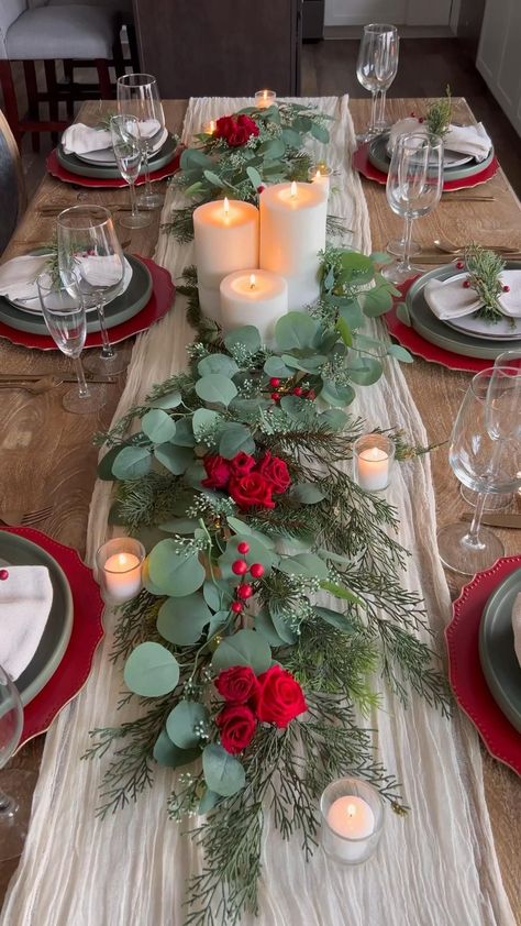 Decorate with fresh greenery like cedar or fir garlands along the table, accented by wooden elements like slice chargers or tree trunk coasters. Use earthy tones for dinnerware and include small pinecones and berries for decoration. Christmas Dining Table Decorations, Dining Table Decorations, Christmas Dining Table Decor, Christmas Getaways, Red Tablecloth, Christmas Dining Table, Dinner Table Setting, Christmas Themes Decorations, Christmas Decorations For The Home