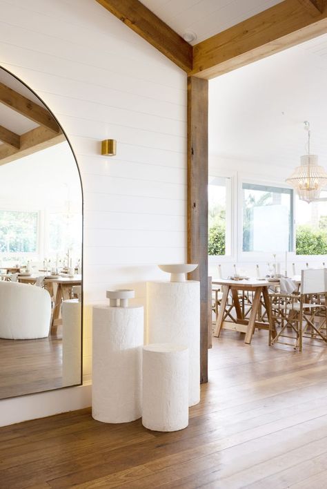 Renovated farmhouse with timber beams and flooring. White VJ walls and styled plinths. Large Arch Mirror, Tree Restaurant, Globe West, Farmhouse Interior Design, Timber Beams, Hardwood Furniture, Arch Mirror, Reclaimed Timber, Farmhouse Interior