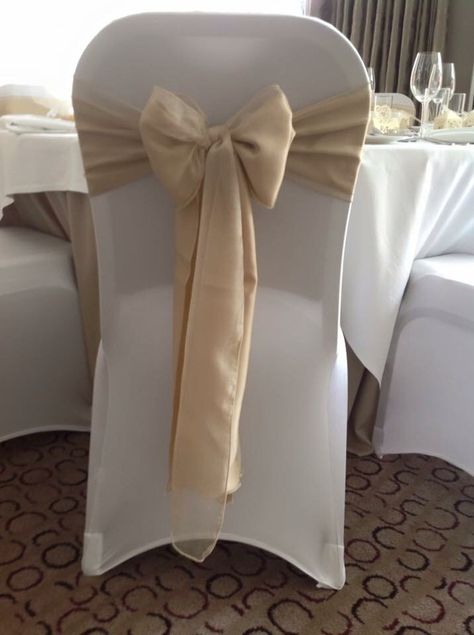 White chair covers with gold sash Engagement Dinner Ideas, Gold Chair Covers, White Seat Covers, Wedding Chair Cover, Cream Chair, White Chair Covers, Engagement Dinner, Gold Centerpieces, Daughters Wedding