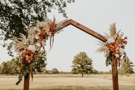 Muted sunset tones on wedding arbor Wedding Ceremony Arbor Ideas, Unique Wedding Arbor Ideas, Fall Wedding Arbor Decor, Arbor Ideas Wedding Rustic, Fall Arbor Decorations, Boho Wedding Arbor Ideas, Terracotta Wedding Arbor, Fall Wedding Arbor Flowers, Boho Arbor Wedding