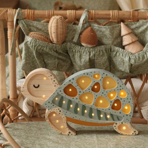 Introducing our serene Turtle Lamp, the perfect coastal companion for your little one's bedroom! Handcrafted from 100% natural pinewood, this adorable turtle embodies both durability and charm, effortlessly complementing any seaside-inspired decor. With its adjustable brightness and convenient timer, your little explorer can slowly drift off to sleep, guided by the tranquil glow of their very own seaside friend. Every Little Lights lamp is hand made, hand painted, and built from natural pine wood – so they don’t just last through childhood, they last generations. Little Lights is a family owned and operated business, all of their unique, handmade products are individually and carefully manufactured at their workshop (and home) in Krakow, Poland. Product Details: Dimensions: 13" x 8" x 2" E Nursery Turtle Theme, Kids Night Lamp, Sea Turtle Nursery Theme, Nursery Lamp Ideas, Neutral Ocean Nursery, Turtle Nursery Theme, Aquarium Nursery, Wall Led Lights, Sea Turtle Nursery