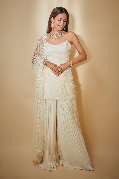 Luxury Off White Sharara With Cutdana, Luxury Off White Sharara With Dabka Work, Luxury Off White Sharara With Resham Embroidery, Luxury Off White Sharara With Zari Work, Luxury Sleeveless Sharara With Zari Work, Luxury Off White Sharara For Navratri, Luxury White Kurta With Mirror Work, Luxury White Sharara For Festive Occasions, Luxury Off White Cutdana Sharara