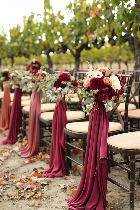 Walk down the aisle surrounded by nature's bounty 🍇. This vineyard wedding captures the essence of romance with stylish wine-colored accents amidst lush grapevines and rustic barrels. Say 'I do' in a setting where love and wine flow endlessly 🍷💍. #WeddingInspiration #VineyardWedding #WeddingDecor #RomanticWeddings #RusticChic #OutdoorWeddings #WeddingIdeas #DreamWedding Red Wedding Chairs, Burgundy Aisle Decor, Wine Red Wedding Decorations, Burgundy Wedding Aisle, Wedding Aisle Red, Wine Vineyard Wedding, Wine Red Wedding, Wedding Ceremony Seating, Wedding Chair Sashes