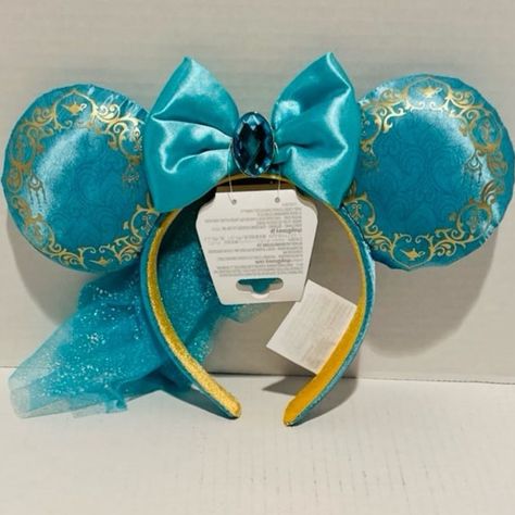 Disney Aladdin Jasmine Ear Headband Nwt * Soft Padded Satin Ears * Ears Feature Screen Art Design Detailed With Gold Filigree Around The Edge * Satin Bow With Large Faceted Gem In The Center * Attached Mesh Veil * Satin Headband Exterior With Screen Art Design * Contrasting Non-Slip Velour Interior * One Size Fits Most Adults * Polyester * 10 4/5'' X 10 2/3'' X 1 1/3'' Aladdin And Jasmine, Disney Aladdin, Disney Accessories, Gold Filigree, Ear Headbands, Aladdin, Blue Gold, Design Details, Hair Accessories