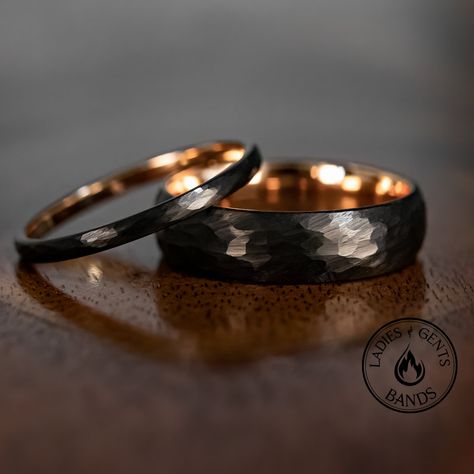 Your wedding ring set order includes + One 6mm Black Hammered Obsidian-styled tungsten Wedding Band with Rose Gold inlay + One 2mm Black Hammered Obsidian-styled tungsten Wedding Ring with Rose Gold inlay + Both Come inside Wax Sealed Ring Boxes. Limited Time: Free Matching Set of Black Silicone Bands w/ Order. *Durable - Incredibly Scratch-Resistant to always look great. *Comfort-fit & Weighty - Designed to fit well and feel good in your hand. *Made to order - Every ring we ship is unique and o His Her Wedding Rings, Matching Bands His And Hers, Wedding Ring Sets Black, Gold And Black Wedding Ring, Mens Tungsten Rings, Viking Wedding Band, Wedding Ring Rose Gold, Woman Wedding Band, Black Wedding Rings Women