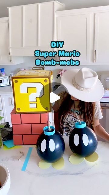 Trish 💕 Beautiful Lifestyle Blogger on Instagram: "DIY Super Mario Bomb-omb’s 💣 ⭐️ Comment “bomb” for the links! I thought it would be fun to create a 3D birthday backdrop for my Husband’s birthday 🥳 And when I saw these little bombs, I knew I had to make them! I used black balloons  Card stock paper, tape, and rope! I thought they turned out so cute! And they’re super easy to make! Tag me if you make your own! I’d love to see them! 😃 💣⭐️  . . #supermario #mario #mariobros #supermariobros #bomb #diy #diycrafts #diyhomedecor #diyprojects #diycraft #diyproject #diyparty #diypartydecor #party #partydecorations #partydecor #partyideas #partydecorations #partytime #partyinspiration #partyballoons #balloons #partyplanner #partydetails #partydecoration #partyplanning #makeitwithmichaels #hob Super Mario Brothers Diy Decorations, Diy Super Mario Backdrop, Mario Birthday Party Dollar Tree, Mario Backdrop Birthday Party Ideas, Diy Mario Banana Peel, Mario Kart Balloon Garland, Mario Bros Birthday Party Decoration, Mario Party Balloons, Diy Mario Decorations Birthday Party Ideas