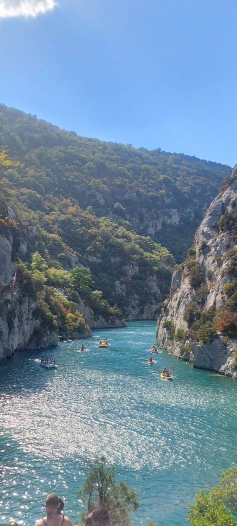 Blue river surrounded by grey mountains with boats Holidays Aesthetic, Travel In France, Summer Mountains, Aesthetic Places, French Summer, France Aesthetic, Streets Of Paris, Places In Europe, Nice France