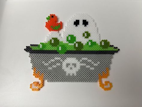 Ghost taking a bath in a green potion:) This ghost bathing in a spooky bath makes for the perfect decoration or gift just in time for Halloween! It looks great on walls and fridges! This ghost fella was hand crafted and ironed on both sides to ensure sturdiness. These beads are sturdy but will break if roughly handled! Each item is made to order, so items may appear different than pictured. Please don't hesitate to reach out if there are any questions  Thank you so much for your time and feel fr Perler Bead Patterns Spooky, Iron Beads Halloween, Best Perler Bead Patterns, Perler Bead Inspiration, Iron Bead Art Ideas, Hama Beads Halloween Pattern, Halloween Fuse Beads, Spooky Perler Bead Patterns, Adult Perler Bead Patterns