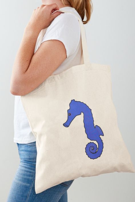 This design features a blue sea horse. Perfect for people that like seahorses, the color blue, and sea animals. This design is drawn and made by leaping-doe. Click on the link to buy!💖 Blue Tote Bag For Beach, Blue Tote Canvas Bag For Beach, Beach Season Sand-colored Tote Shoulder Bag, Blue Seahorse, Nautical Beach Tote Bag, Ocean Tote Bag, The Color Blue, Sea Horse, Seahorses