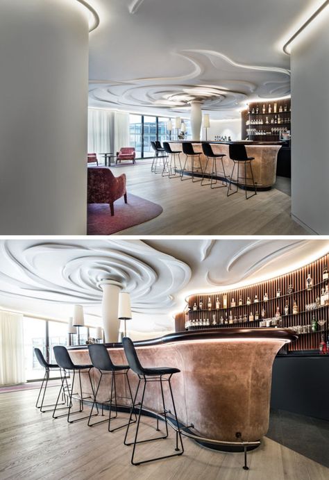 Nature was the inspiration in this modern bar and lounge area, and it has been represented through a 100-sq-m sculpted rose on the ceiling. #Ceiling #Sculpture #Bar Ceiling Sculpture, Curved Bar Design, Interior Design Hotel, Bar Counter Design, Modern Home Bar, Curved Bar, Counter Design, Hotel Interior Design, Bar Interior