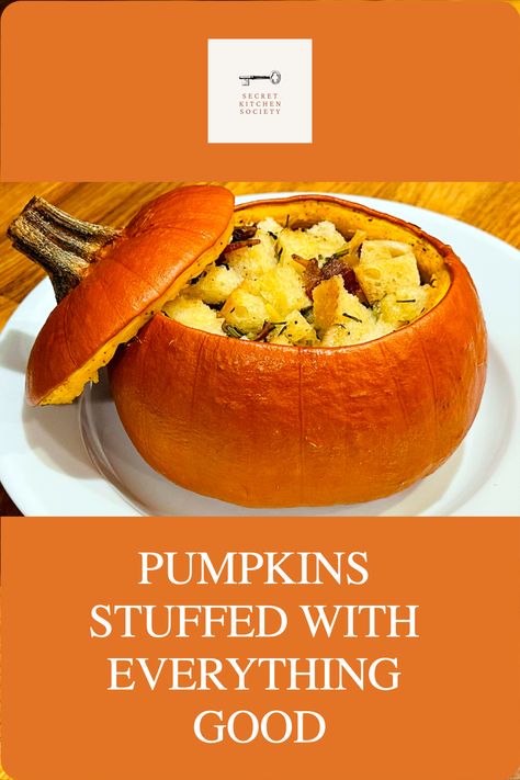 Small roasted pumpkin stuffed with bread cubes, bacon, and herbs with its lid resting alongside on a white plate. Stuffed Pumpkin Recipes, Pumpkin Bake, Jarrahdale Pumpkin, Whole Pumpkin, Pie Pumpkins, Vegetarian Stew, Pumpkin Varieties, Stuffed Pumpkin, Stuffing Ingredients