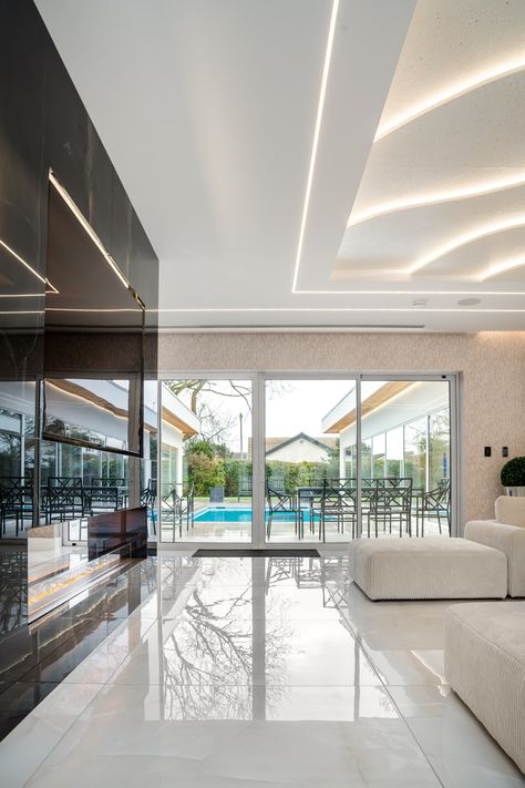 Luxury is all in the details—like the elegant Madre Blanco Onyx tiles that grace this luxurious living room with a view of the outdoor swimming pool 🏊‍♂️.⁠ Living Room With A View, White Floor Tiles, Modern Floor Tiles, Onyx Tile, Luxurious Living Room, White Tile Floor, Polished Porcelain Tiles, Flooring Tiles, Room With A View