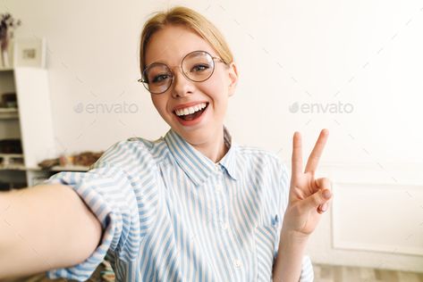 Photo of joyful blonde woman showing peace sign while taking selfie by vadymvdrobot. Photo of joyful blonde woman in eyeglasses showing peace sign while taking selfie photo at office #Sponsored #woman, #showing, #peace, #Photo Peace Sign Drawing, Woman Architect, Waving Hand, The Office Characters, Photo Of Woman, Vector Graphics Design, How To Shade, Blonde Woman, Piece Sign