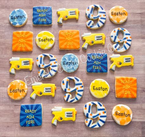 Nerf Cookies Decorated, Nerf Cookies, Nerf Themed Birthday Party Food Ideas, Nerf Party Food, Nerf Birthday Shirt Ideas, Nerf Party Shirts, Nerf Birthday Party Games Shooting Range, Nerf Cake, Nerf Birthday Party