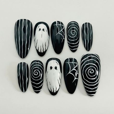 Get spooky with our White Ghost Illusion Halloween press-on nails! Featuring a striking black and white spider web design, these custom, reusable press-ons are perfect for adding a hauntingly stylish touch to your Halloween look. Embrace the season with these trendy, personalized nails. 🌸Thank you for supporting my small business.🌸 You can reuse all the nails you purchased from us multiple times, if you handle them with care 📦𝐖𝐡𝐚𝐭 𝐜𝐨𝐦𝐞𝐬 𝐰𝐢𝐭𝐡 𝐲𝐨𝐮𝐫 𝐩𝐫𝐞𝐬𝐬 𝐨𝐧 𝐧𝐚𝐢𝐥 𝐤𝐢 Black Silver Halloween Nails, Halloween 2024 Nail Art, Black Nails With Swirls, Spooky Press On Nails, Simple Black And White Halloween Nails, Halloween Nails Long Stiletto, Spider Web Halloween Nails, Nail Ghost Design, Black Nails Halloween Art Designs