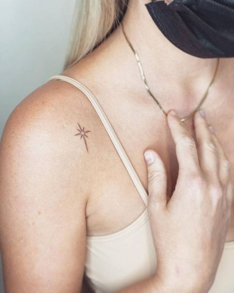 Minimalist north star tattoo on the shoulder. Dainty North Star Tattoo, Arrow And Star Tattoo, Collarbone Star Tattoos For Women, North Star Tattoo Shoulder, North Star Tattoo Behind Ear, Fine Line North Star Tattoo, Star Tattoo Ribcage, Star On Shoulder Tattoo, Bethlehem Star Tattoo