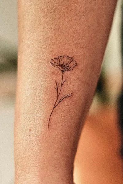 Exploring the World of Poppy Flower Tattoos - Tweakbee Poppy Arm Tattoos For Women, Iceland Poppy Tattoo, Poppy Tattoo Behind Ear, California Poppy Tattoo Simple, Matilija Poppy Tattoo, Delicate Poppy Tattoo, Yellow Poppy Tattoo, Poppy Tattoo Minimalist, Poppy Tattoos For Women