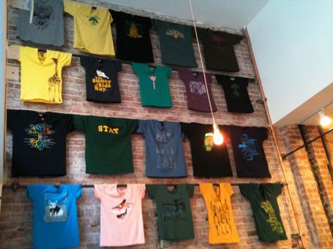 T-shirts displayed in the new Oaklandish store. Store Displays Ideas, T-shirt Display, Tshirt Display, Shirt Display, Clothing Displays, Retail Merchandising, Store Fixtures, Merchandising Displays, Store Displays