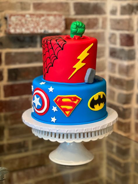 Cake Designs Superhero, Marvel Vs Dc Birthday Cake, Superhero First Birthday Cake, 2 Tier Superhero Cake, Super Heroes Cakes, Cake Ideas For 4 Year Boy, Superhero Themed Cake, Superhero Party Cake, Superheroes Birthday Cake