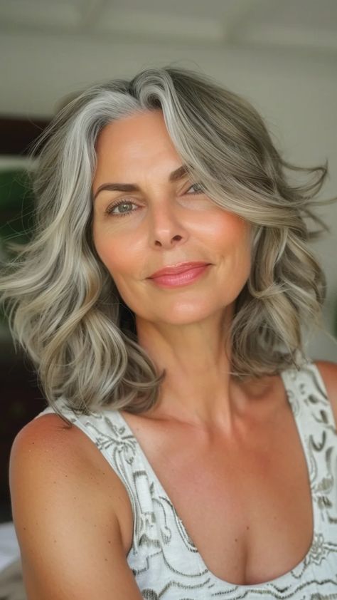 Smiling woman with wavy, gray hair and a patterned sleeveless top. Gray Lob Hairstyles, Grey Hair Bob, Gray Bob Hairstyles, Bobs With Bangs, Gray Bob, Grey Bob Hairstyles, Bob Ideas, Chin Length Cuts, Angled Bobs