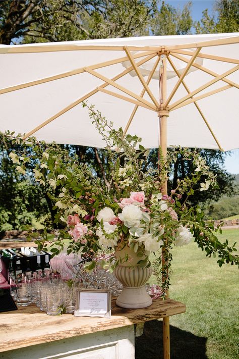 An open air cocktail bar on a big lawn makes for a beautiful garden party setting. Keeping things cool with a sun umbrella over the gorgeous florals! #gardenparty #wedding #outdoorwedding #weddingreception #luxuryweddingplanner Backyard Engagement Parties, Paris Flowers, Whimsical Flowers, Party Vibe, Garden Bridal Showers, Country Garden Weddings, Antique Bar, Garden Party Decorations, Umbrella Wedding