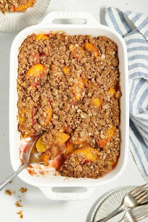 Don't let peach season pass you by without trying this Vegan Peach Crisp! It's loaded with fresh-baked peaches surrounded by a sweet jammy filling and topped with a crispy, buttery crumble. It's simply irresistible! Vegan Peach Crisp, Vegan Crisp, Baked Peaches, Nectarine Recipes, Vegan Peach, Vegan Pastries, Peach Crumble, Baked Peach, Peach Crisp