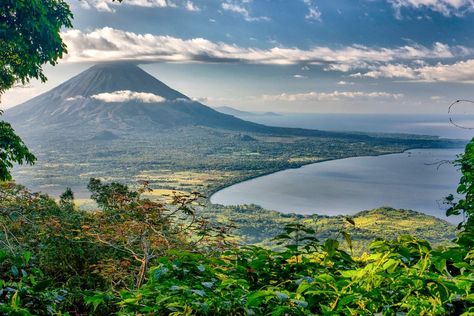 With an elevation of 32.7 metres (107 ft) above sea level, the lake reaches a depth of 26 metres (85 ft). It is intermittently joined by the Tipitapa River to Lake Managua. The lake drains to the Caribbean Sea via the San Juan River, historically making the lakeside city of Granada an Atlantic port, although Granada (as well as the entire lake) is closer to the Pacific Ocean geographically. The Pacific is near enough to be seen from the mountains of Ometepe (an island in the lake). El Salvador Culture, Lake Nicaragua, Ometepe, Nicaragua Travel, Lake Titicaca, Lake Landscape, Latin America, Central America, Nature Travel