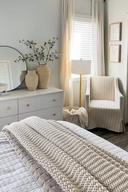 White Dressers In Bedroom, Chair Next To Dresser, Neutral Dresser Decor, White Bedroom With Gold Accents, Bedroom With White Dresser, Bedroom Decor White Furniture, White Dresser Bedroom Decor, White Bedroom Furniture Decor, Farmhouse Bedroom Dresser