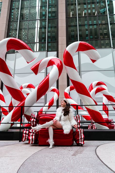 giant candy cane holiday decorations woman wearing white feather coat City Christmas Decorations, Company Christmas Decorations, New York Christmas Decorations, Christmas City Decorations, Christmas Store Decoration, Christmas Set Design, Christmas Event Ideas, Giant Christmas Decorations, Windows Christmas