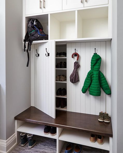 Our creative mudroom design features hidden shoe storage cabinets behind panelled doors dressed with coat hooks, perfect for a family. #allanchandondesign #mudroomdesign #familyfriendlydesign #customcabinetry #shoestorage #transitionaldesign #torontointeriordesign #torontodesigner #etobicoke #torontocustomhomes ���📷@valeriewilcox Skjulte Rum, Ikea Shoe Storage, Vstupná Hala, Farmhouse Mudroom, Ikea Shoe, Coat Closet Organization, Paint Cabinets White, Entryway Closet, Cabinets Painted