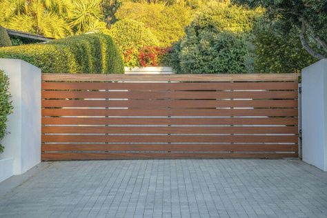 20 Driveway Gate Ideas to Suit Every House Style — The Spruce Wooden Driveway Gate Ideas, Driveway Gates Ideas, Modern Gated Driveway Entrance, Driveway Gate Ideas Diy, Driveway Fence Ideas Entrance, Privacy Gates Driveway Entrance, Sliding Gate Driveway, Modern Driveway Gate, Modern Gates Driveway