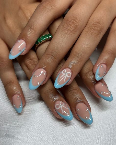 Baby Blue Bow Set 🎀🩵 • • • Apres Natural Almond Medium • IGel (I’m Blushing) • • #nails #nailsnailsnails #nailsofinstagram #nailsart #nailsbyavryl #gelx #gelxnails #gelxnailtech #explorepage #frenchtipnails #almondnails Blue Nails With Bow, Blue Bow Nails, Blushing Nails, Light Blue Nails With Design, Apres Nails, Bow Nails, Light Blue Nails, Baby Blue Nails, Graduation Nails