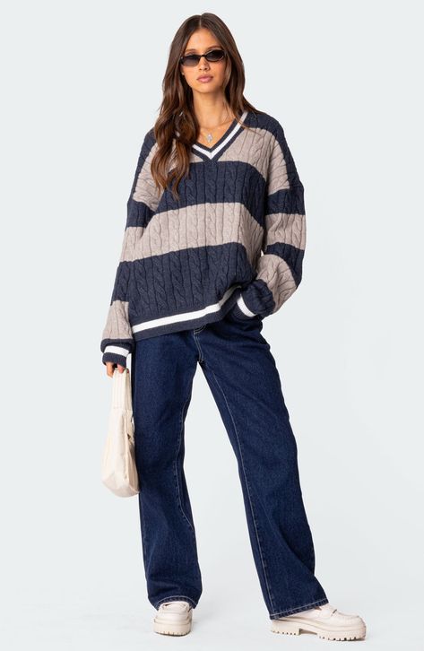 Add a varsity-inspired element to your wardrobe with this boldly striped V-neck sweater cut in an oversized fit with slouchy dropped shoulders. V-neck Long sleeves Dropped shoulders Ribbed cuffs and hem 50% polyester, 50% rayon Machine wash, dry flat Imported V Neck Cable Knit Sweater, Fall Streetwear, Loose Pullover, Warm Sweaters, Women Sleeve, Cable Knit Sweater, Winter Sweaters, V Neck Sweater, Costumes For Women