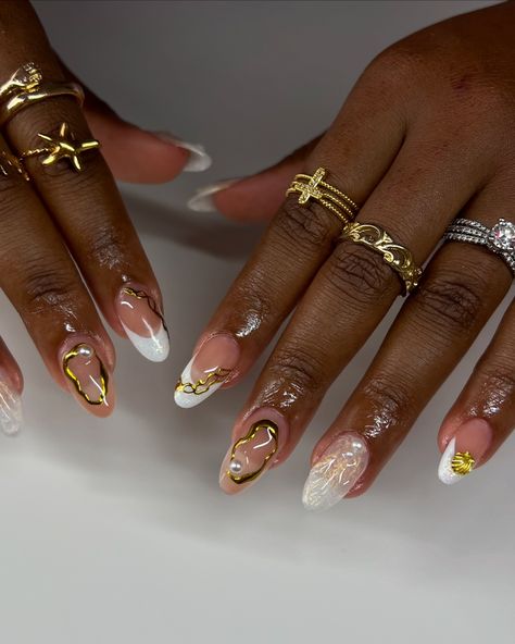 ✨🐚🌞 @shopagaloreco products used: *malt base *ultra white *gold fairy *bling gel *diamond steel top coat use code ‘ALEXIA10’ at checkout 🤎 #nails #nailinspo #nailideas #naildesign #nailartist #whitenails #shellnails #beachnails #cutenails #almondnails #pearlnails #cltnails #cltnailtech #gelx #gelxnails #gelxinspo #gelxnailtech #almondnails Gold And White Nails, Ultra White, Pearl Nails, Beach Nails, Nail Artist, Almond Nails, Nail Tech, White Nails, Fake Nails