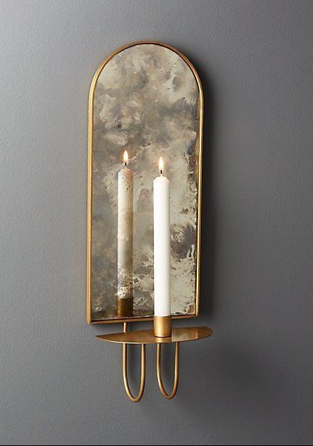 light reflections. Curved iron wall sconce in brass finish holds one taper candle. Antiqued mirror backing brilliantly reflects the light. We love it in pairs flanking a bed or doorway, or clustered in multiples for extra drama. CB2 exclusive. #cb2 #walldecor #entrywaydecor #mirrorwalldecor Wall Sconces Living Room, Antiqued Mirror, Sconces Living Room, Unique Candle Holders, Iron Wall Sconces, Modern Candle Holders, Modern Candles, Candle Mirror, Sconces Bedroom