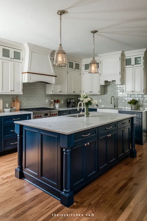 Modern kitchen with navy island, white cabinets, and pendant lights. Dark Blue And White Cabinets Kitchen, Navy Bottom Cabinets White Top, Navy Blue Kitchen Cabinets With Brushed Nickel Hardware, Howdens Marine Blue Kitchen, White And Dark Blue Kitchen, Navy Blue And White Kitchen Cabinets, Blue Gray Cabinets, Blue Lower Kitchen Cabinets, White Kitchen Navy Island