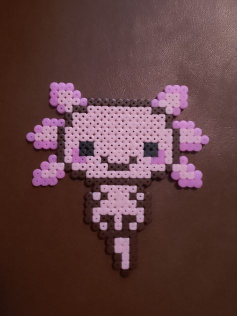 An axolotl Axolotl Melty Beads, Axolotl Fuse Beads, Axolotl Pearl Beads, Perler Axolotl, Axolotl Bead Pattern, Axolotl Perler Bead Patterns, Beaded Axolotl, Axolotl Perler Beads, Axolotl Crafts