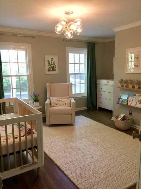 Modern green and floral nursery Boho Sage Nursery, Nursery Rug Sage Room, Sage Green And Floral Nursery, Baby Girl Nursery Sage Green, Sage And Pink Floral Nursery, Sage Nurwsery Wallpaper Accent, Sage Nursery, Floral Nursery, Cribs