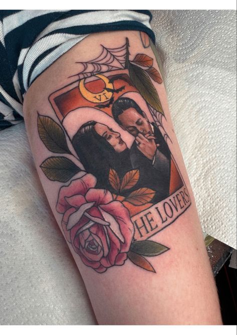 Neo traditional tarot card tattoo of morticia and gomez adams in autumnal colours on the back of an arm Gomez Morticia Tattoo, Morticia And Gomez Tattoos, Mortician And Gomez Addams Tattoo, Lovers Card Tattoo, Morticia Addams Tattoo Ideas, Morticia And Gomez Tattoo, Morticia And Gomez Tattoo Traditional, Morticia Tattoo, Spooky Love Tattoo