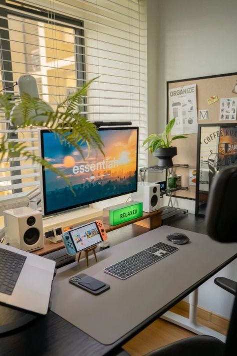 This sleek and modern desk setup creates the perfect balance between productivity and relaxation. With clean lines, a multi-screen workstation, and a relaxing ambiance enhanced by plants and soft lighting, it’s ideal for both work and leisure. The desk is equipped with all essentials, from a Nintendo Switch for breaks to a wireless keyboard and laptop stand for seamless work. Perfect for anyone looking for home office inspiration that is both functional and stylish. Macbook Desk Setup Aesthetic, Laptop Setup Ideas, Laptop And Monitor Desk Setup, Modern Desk Setup, Ideal Workplace, Home Studio Desk, Workstations Design, Boys Room Design, Home Office Inspiration