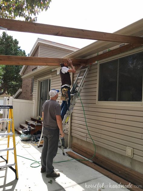 Building a pergola attached to the house. How to attach cross beams to the header. Housefulofhandmade.com How To Attach A Pergola To A House, Building A Pergola Attached To House, How To Attach, How To Anchor Pergola To Concrete, How To Build A Pergola, Patio Awning Attached To House, Pergola On Patio, Build An Awning, Plant Landscaping Ideas