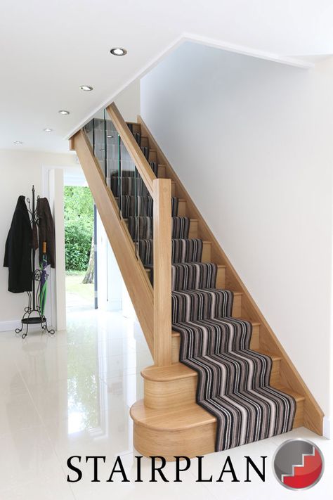 Houston Oak Staircase with glass balustrade striped carpet runner Oak And Glass Staircase, Stairs With Glass Panels, Staircase Layout, Staircase Manufacturers, Balustrade Design, Timber Staircase, Spiral Staircases, Oak Stairs, Glass Stairs