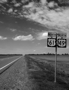 'Blues Highway' intersection of Highways 61 and 49—the crossroads, legend claims, where aspiring blues musician Robert Johnson sold his soul to the devil in exchange for the prodigious guitar-playing skills he acquired. Highway 61 carried poor rural musicians and sharecroppers out of the dusty Mississippi cotton fields in the 1930s and ’40s north towards Memphis and St. Louis, where audiences first clamoured for the raw, emotional singing and guitar playing that emerged from the Jim Crow Sou... Mississippi Delta Blues, Clarksdale Mississippi, Blues Music Poster, All Shades Of Blue, Mississippi Blues, Delta Girl, Mississippi Delta, Robert Johnson, Delta Blues