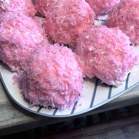 Seven homemade pink sno-balls, like Hostess Sno-balls, covered in meringue and pink coconut on a blue and white tray Hostess Snowballs Recipe, Pink Snowball Puffs, Snowball Brownies, Snow Balls Recipe, Pink Christmas Treats, Sno Ball Recipe, Homemade Snowballs, Snowball Recipe, 80s Snacks