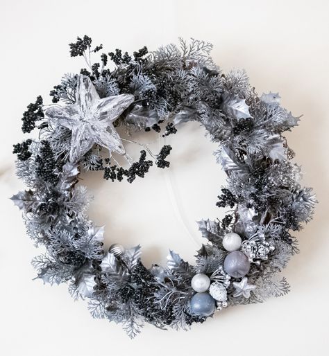 A grapevine wreath with a stunning combination of black, grey, and silver. Sister stars are above black berries, silver foliage, and sparkly pinecones. 18 inches Black Berries, Winter Solstice, Grapevine Wreath, Black Grey, Grape Vines, Wreath, Trees, Stars, Grey